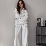 Completo due pezzi con felpa con cappuccio e mezza zip e stampa di lettere, pantaloni larghi e dritti