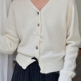 Cardigan con scollo a V, fiocco e bottoni