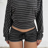 Blusa asimmetrica con spalle larghe e stampa a righe