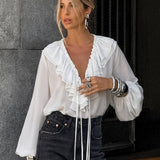 Camicetta bianca con scollo a V e maniche a lanterna