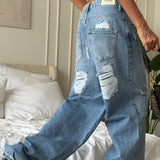 Jeans a gamba larga strappati con cuore vintage
