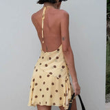 Mini abito in chiffon a pois con scollo all'americana, spacco profondo a V e schiena scoperta