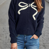 Cardigan rotondo jacquard con fiocco solido