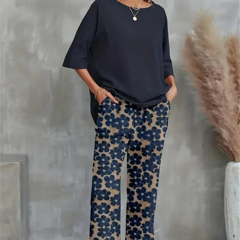 Completo elegante da donna con top asimmetrico e pantaloni larghi a fiori