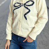 Cardigan rotondo jacquard con fiocco solido