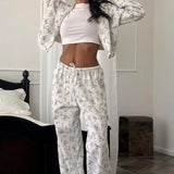 Completo due pezzi con felpa con cappuccio e zip corta a fiori e pantaloni a gamba larga con coulisse