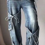 Jeans a gamba larga con cinturino a fiocco