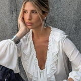 Camicetta bianca con scollo a V e maniche a lanterna