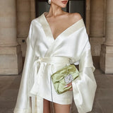 Mini abito a trapezio con scollo a V e maniche lunghe in raso color champagne con cintura annodata in vita