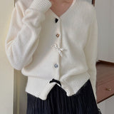 Cardigan con scollo a V, fiocco e bottoni