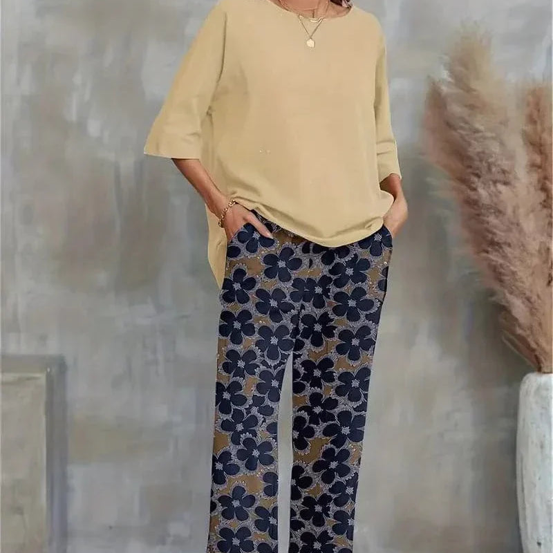 Completo elegante da donna con top asimmetrico e pantaloni larghi a fiori