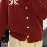 Cardigan rotondo in jacquard con fiocco morbido