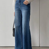 Jeans bootcut a vita alta tinta unita