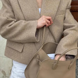 Blazer di lana con spalline e revers a lancia oversize