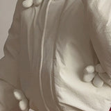 Cappotto casual imbottito con cappuccio e finiture floreali