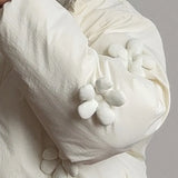 Cappotto casual imbottito con cappuccio e finiture floreali