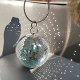 Pochette da polso riflettente con sfera da discoteca