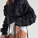 Cappotto corto con cerniera, vita arricciata e frange in tinta unita